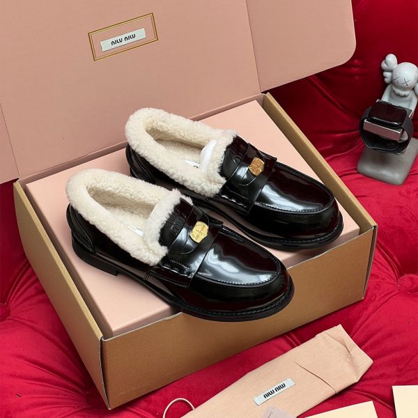 MIUMIU Bleached leather and shearling penny loafers