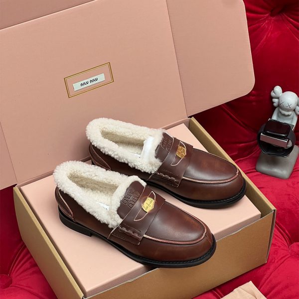 MIUMIU Bleached leather and shearling penny loafers